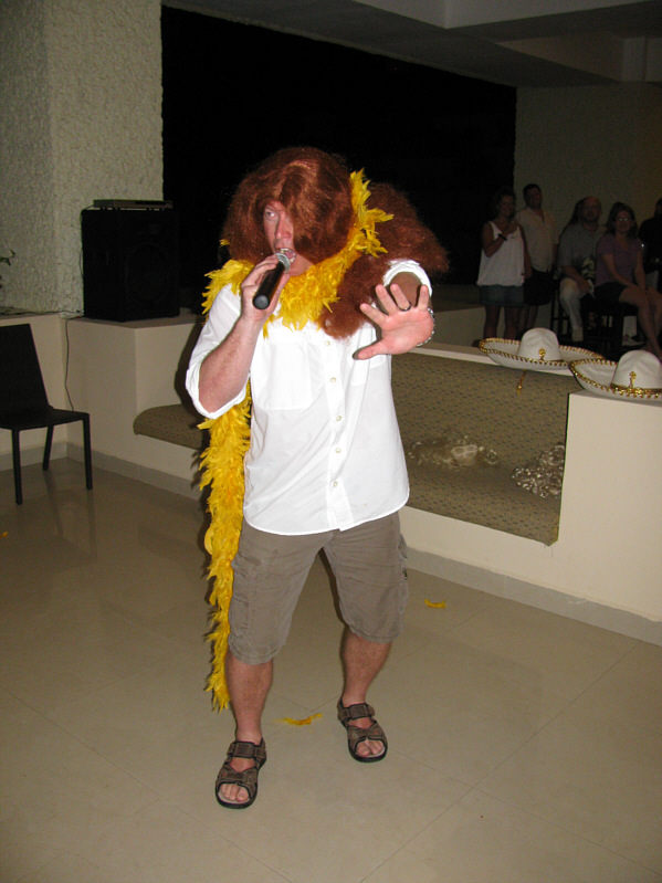 If you've ever wondered what Chris would look like with hippy-long red hair and a feather boa...