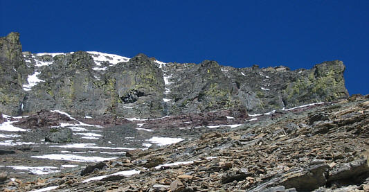 The most sporting finish is to go up a hidden gully near the right edge of the lichen-band.